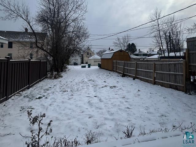 view of yard layered in snow