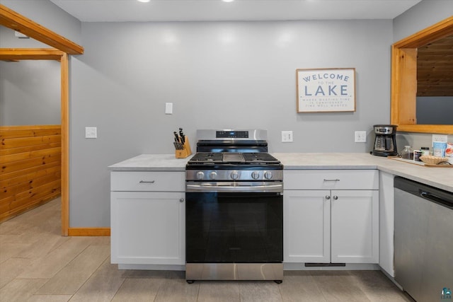 kitchen with white cabinets, light hardwood / wood-style floors, and stainless steel appliances