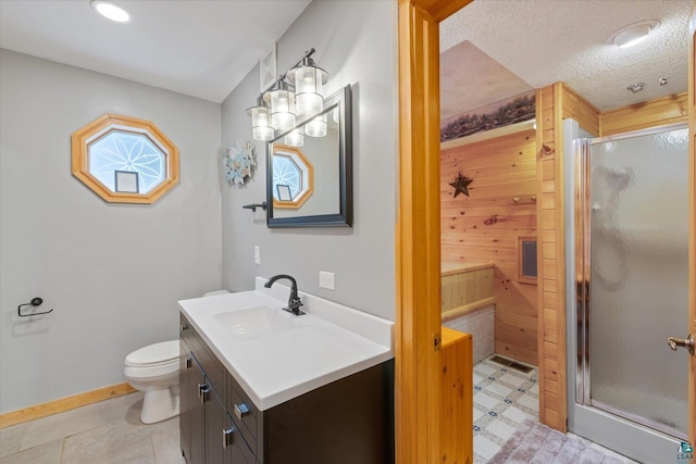 bathroom featuring a textured ceiling, vanity, toilet, and walk in shower