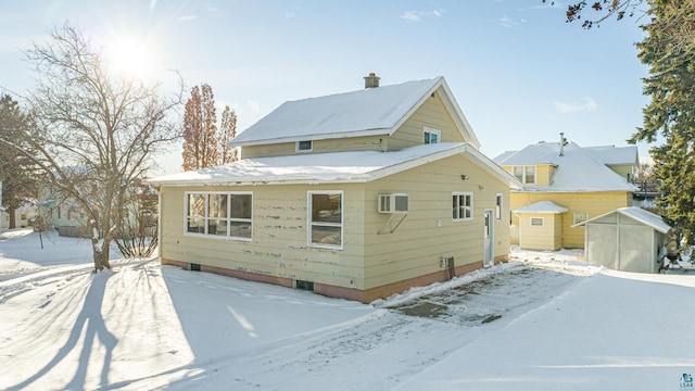 exterior space featuring a wall mounted AC and a storage shed