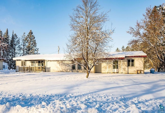 view of snow covered back of property