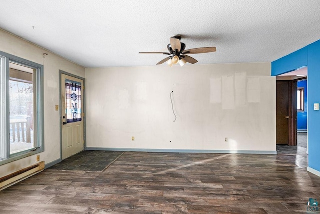 spare room featuring a textured ceiling, dark hardwood / wood-style flooring, ceiling fan, and a baseboard heating unit