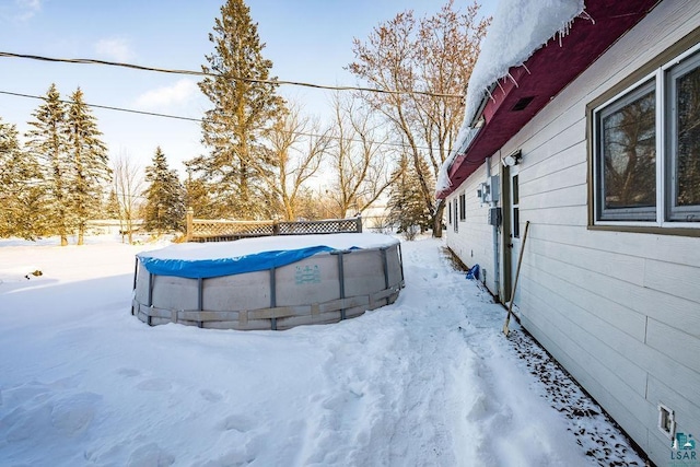 yard covered in snow with a covered pool