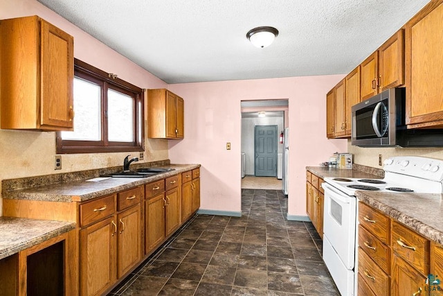 kitchen with a textured ceiling, white electric range, and sink