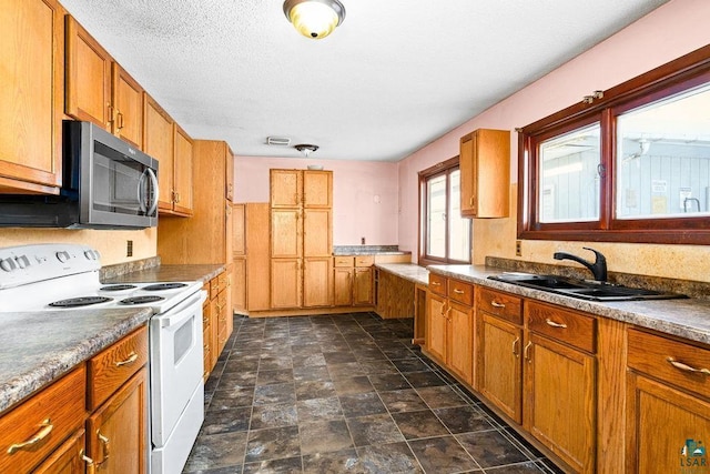 kitchen featuring white electric range, a textured ceiling, and sink