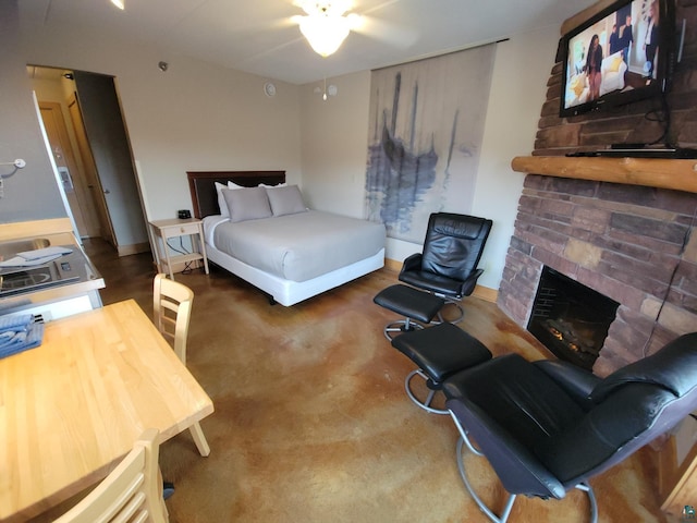 bedroom featuring a brick fireplace and ceiling fan