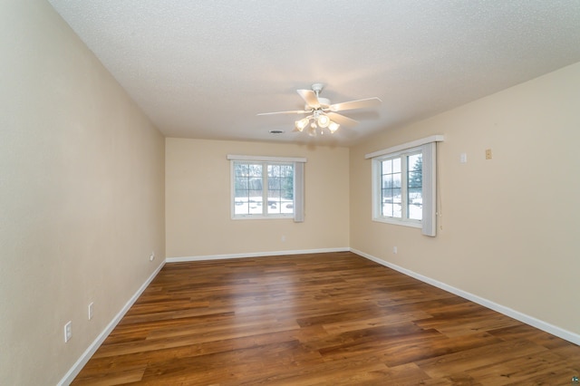 unfurnished room featuring a textured ceiling, dark hardwood / wood-style flooring, and ceiling fan