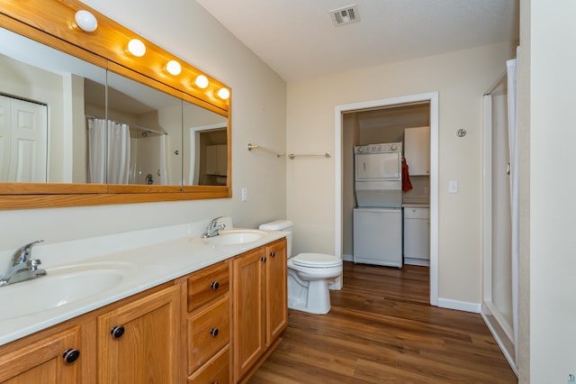 bathroom with a shower with curtain, hardwood / wood-style floors, vanity, and toilet