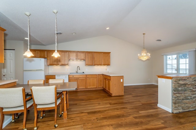 kitchen with decorative light fixtures, white appliances, dark wood-type flooring, and vaulted ceiling