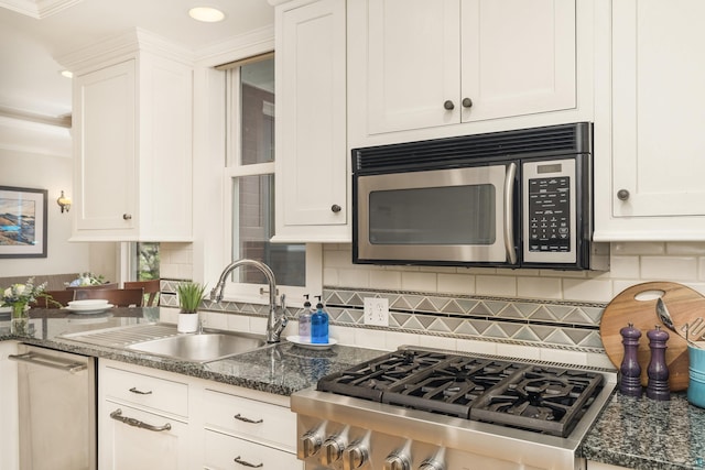 kitchen featuring white cabinets, backsplash, and sink