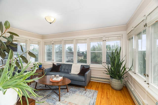 sunroom with a baseboard radiator and plenty of natural light