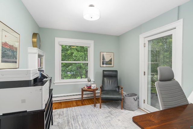 office featuring light hardwood / wood-style flooring and a baseboard heating unit