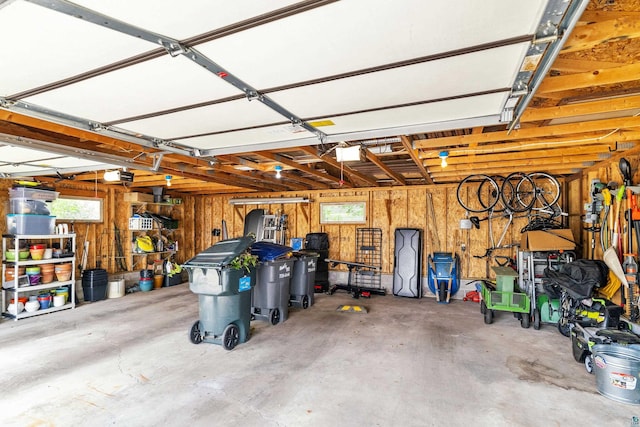 garage featuring wood walls and a garage door opener