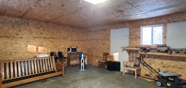 miscellaneous room with concrete floors and a workshop area