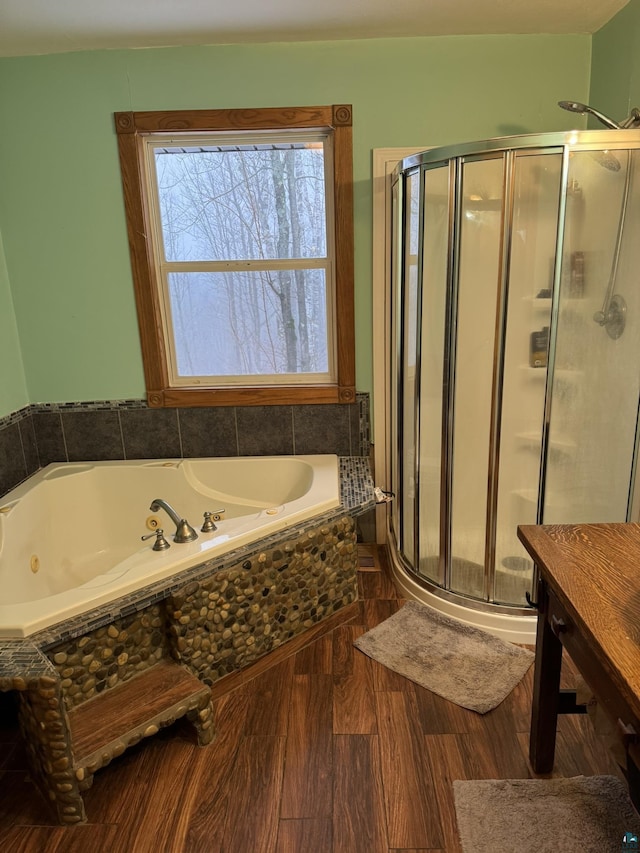 bathroom featuring hardwood / wood-style flooring and separate shower and tub