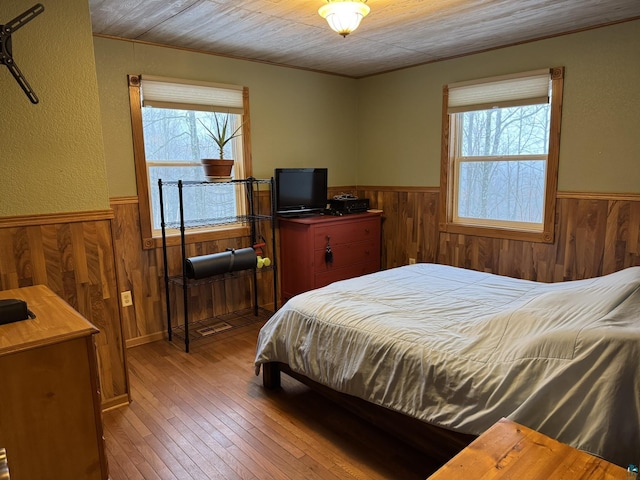 bedroom featuring multiple windows, hardwood / wood-style floors, and wooden ceiling