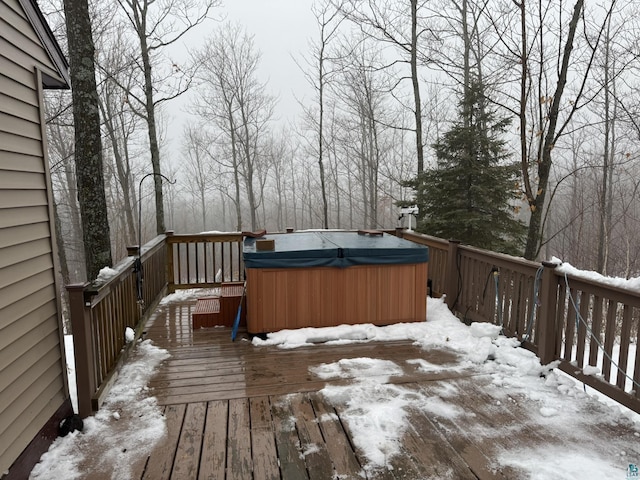 snow covered deck featuring a hot tub