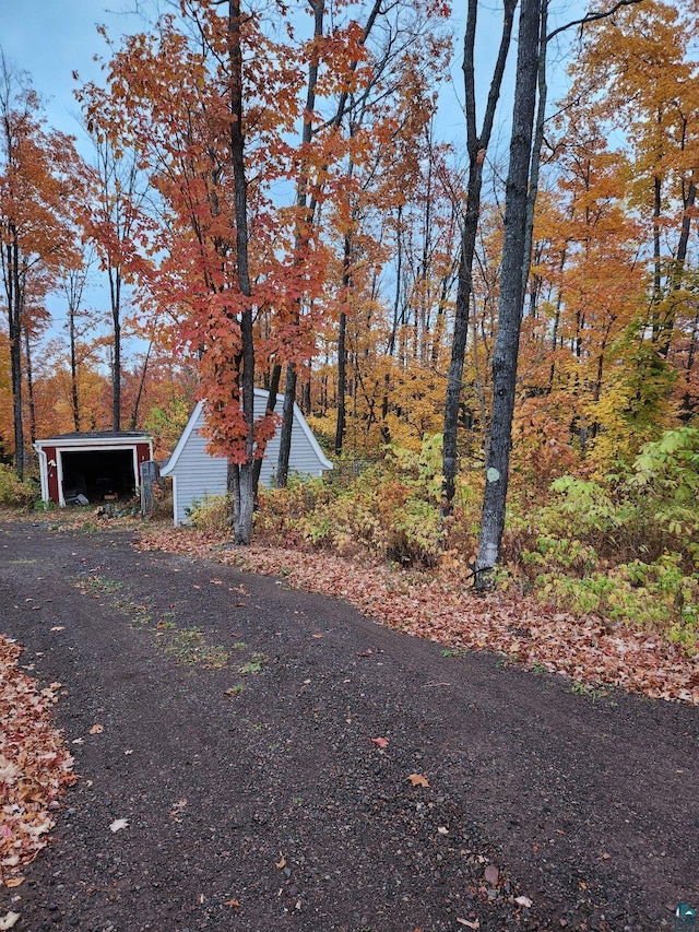 exterior space featuring a garage and an outbuilding