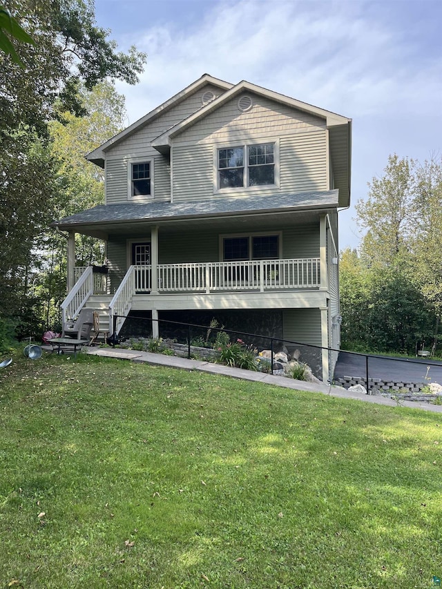 view of front facade featuring covered porch and a front yard