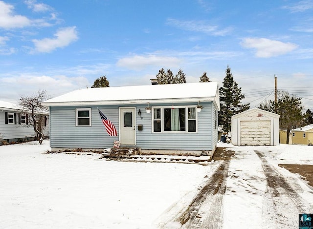 view of front of house with a garage and an outdoor structure