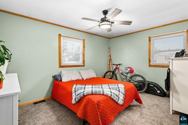 bedroom with carpet flooring, multiple windows, ceiling fan, and crown molding