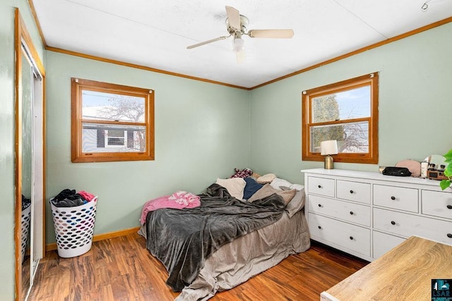 bedroom featuring ceiling fan, crown molding, and dark wood-type flooring