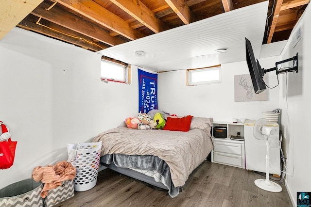 bedroom featuring dark hardwood / wood-style flooring and multiple windows