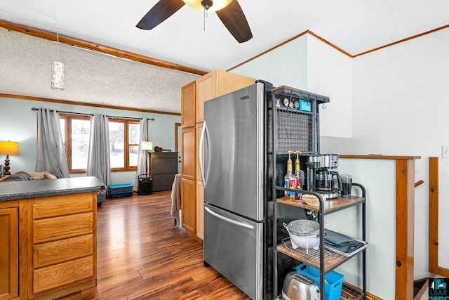 kitchen featuring beam ceiling, stainless steel refrigerator, ceiling fan, light brown cabinets, and dark hardwood / wood-style floors