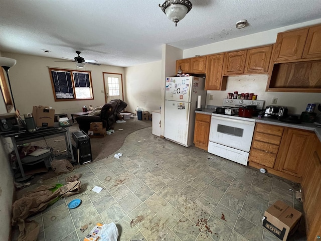 kitchen featuring a textured ceiling, ceiling fan, and white appliances