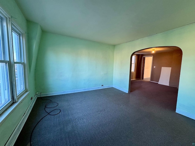 unfurnished room featuring plenty of natural light