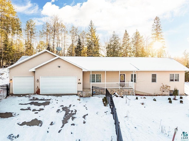 ranch-style home featuring a garage and covered porch