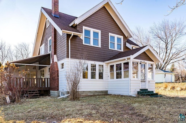 back of property with a sunroom