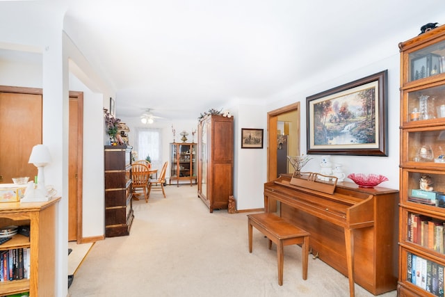 miscellaneous room featuring ceiling fan and light carpet