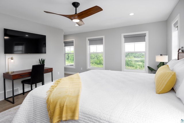 bedroom with hardwood / wood-style flooring and ceiling fan