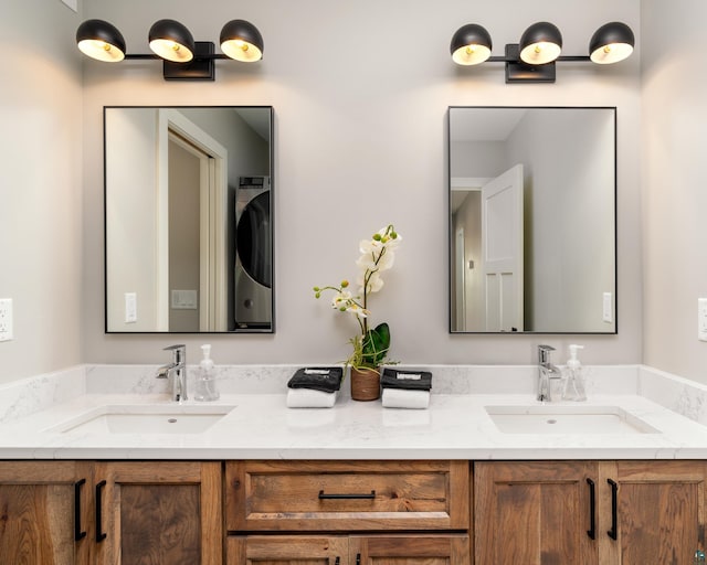 bathroom featuring vanity and washer / clothes dryer