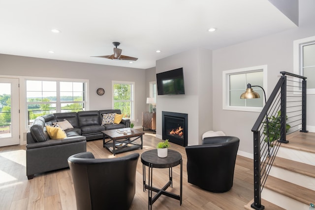 living room with ceiling fan and light hardwood / wood-style floors