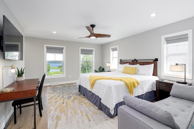 bedroom with ceiling fan and light hardwood / wood-style flooring