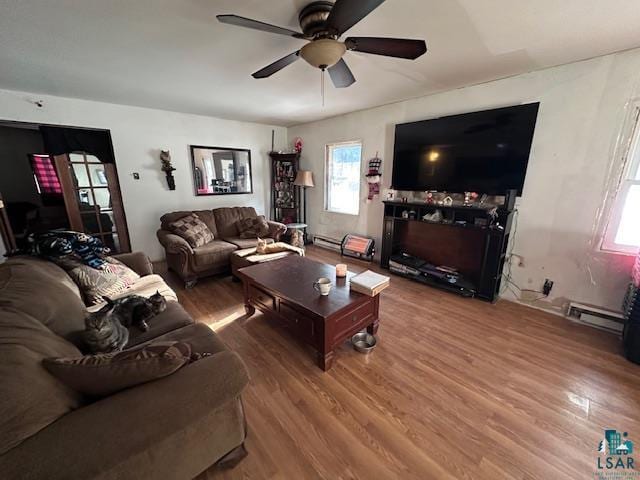 living room featuring hardwood / wood-style flooring, ceiling fan, and a baseboard radiator