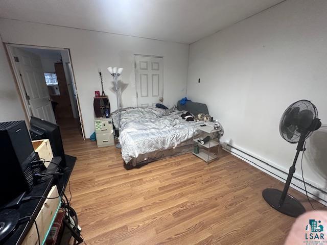 bedroom featuring light hardwood / wood-style floors and a baseboard radiator