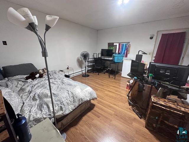 bedroom with hardwood / wood-style floors