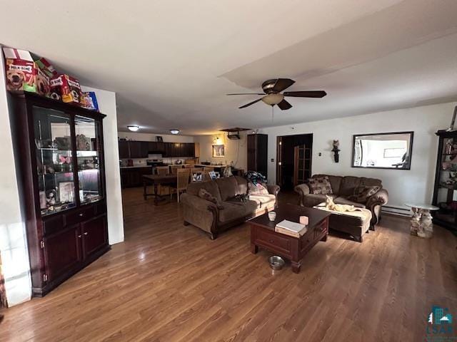 living room with ceiling fan and dark hardwood / wood-style floors