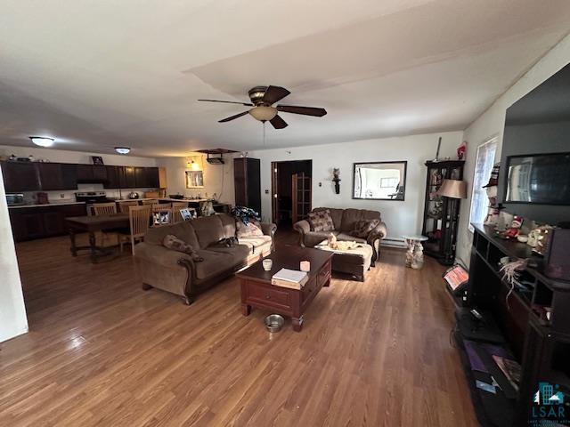 living room featuring wood-type flooring and ceiling fan