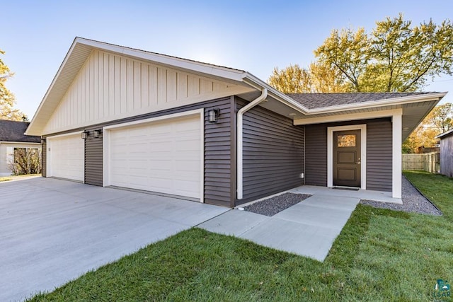 ranch-style house with a front yard and a garage