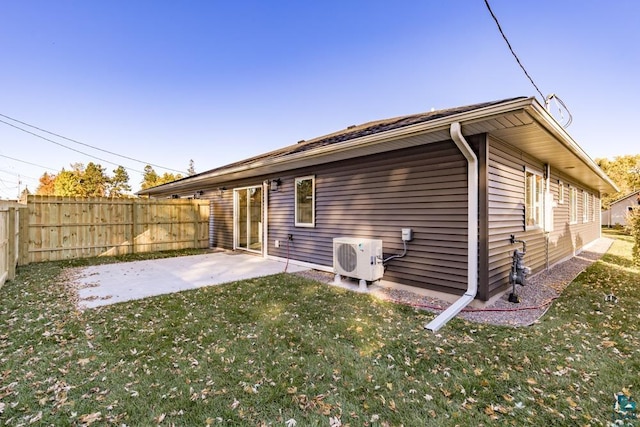 back of house featuring ac unit, a yard, and a patio