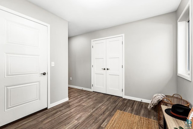 unfurnished bedroom featuring dark hardwood / wood-style floors and a closet