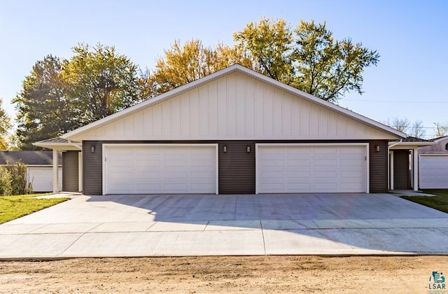 single story home featuring an outbuilding and a garage