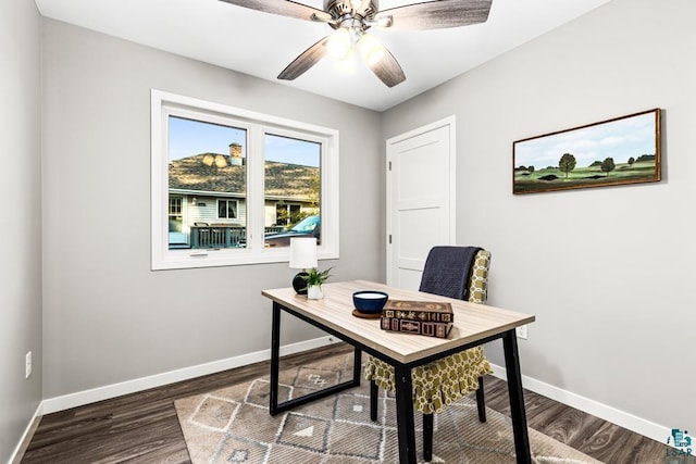 home office featuring ceiling fan and dark wood-type flooring