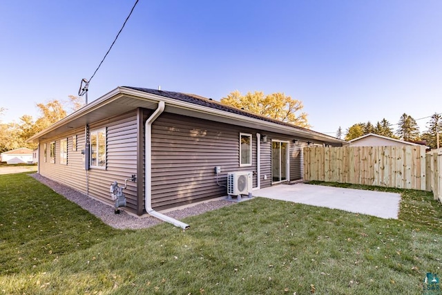 back of house with a lawn, a patio area, and ac unit