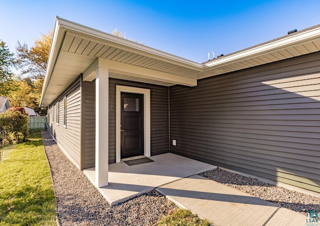 view of exterior entry featuring a patio