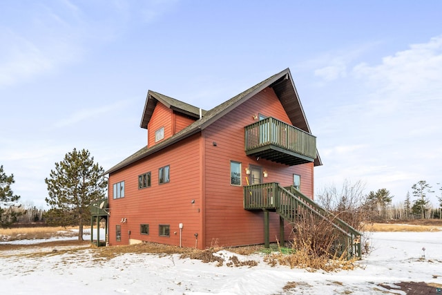 view of snowy exterior featuring a balcony